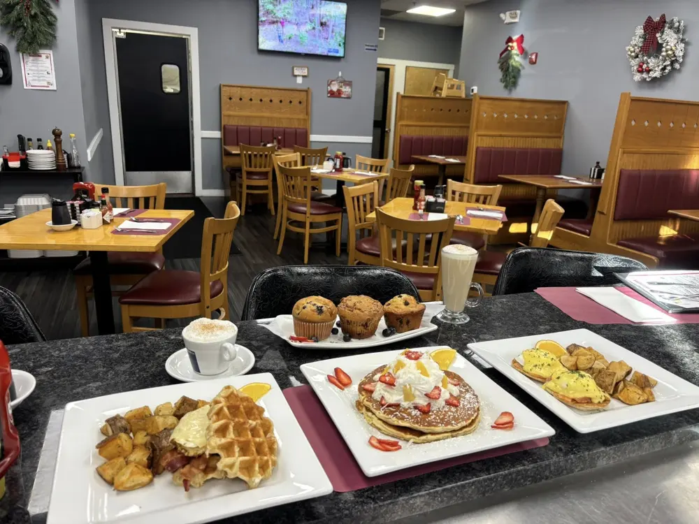 The dining room at Buppa's Breakfast with plates of waffles, pancakes and omelettes